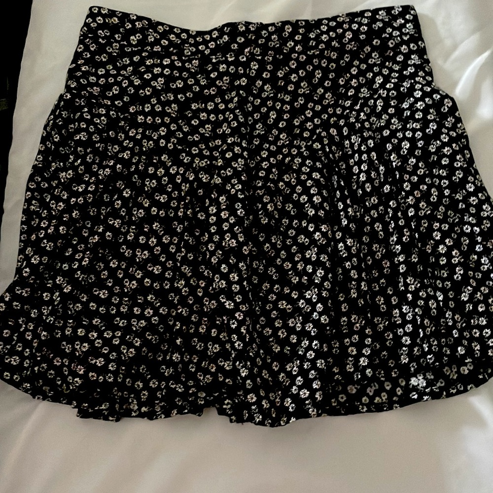 Black mini skirt with small white flower print
